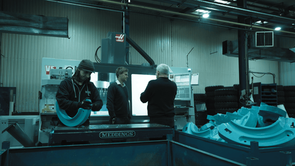 Factory manager and machine operator on factory floor