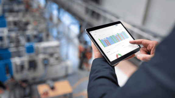 Factory managerusing smart technology to monitor productivity