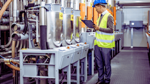 Shop floor supervisor using Lean manufacturing principles to check production line