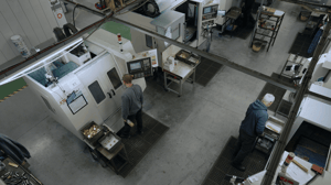 Machine operators on factory floor using xyz cnc machines