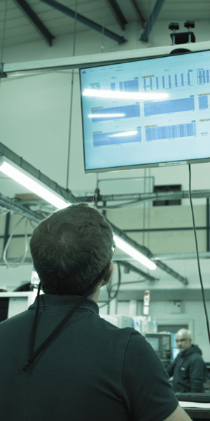 Image shows machine productivity data shown on large screen