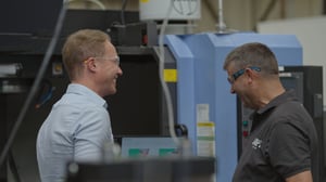 Operations manager talking to shop floor supervisor